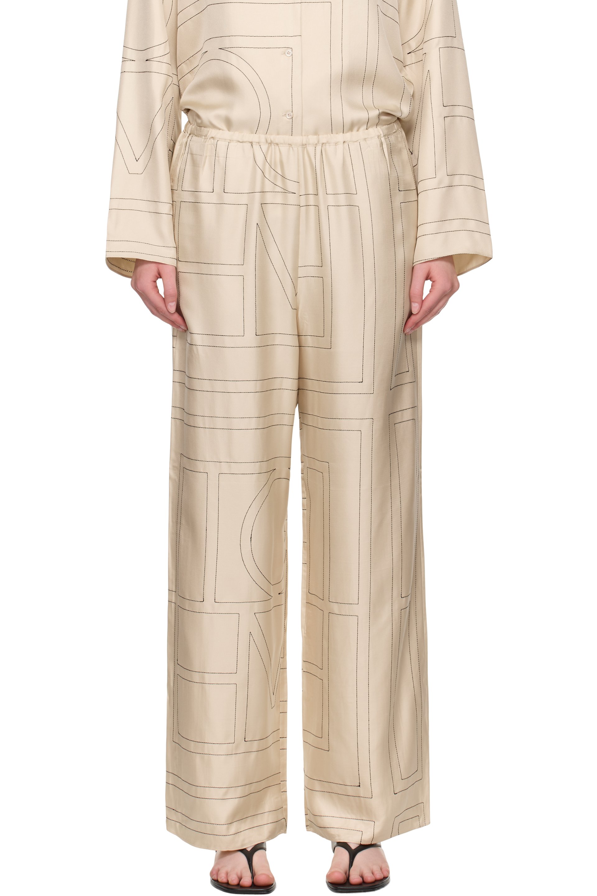TOTEME - Pantalon de détente blanc cassé en soie à monogrammes