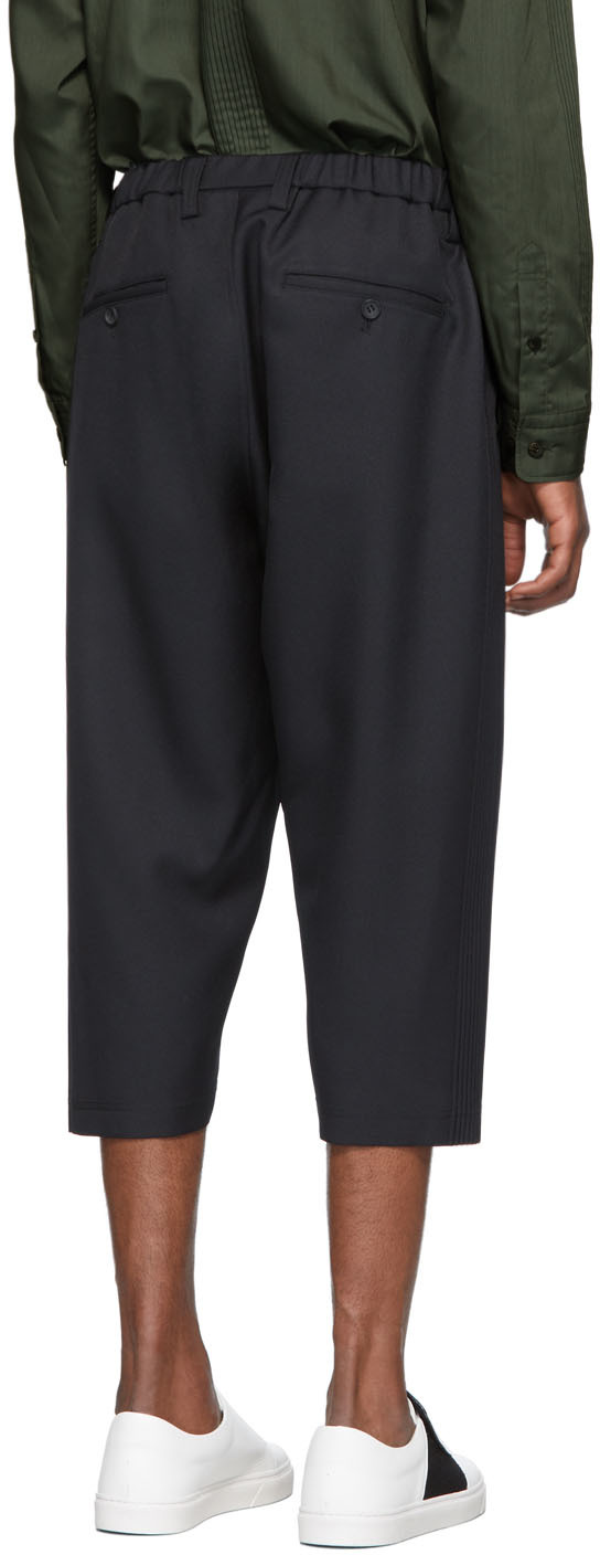 black pleated cropped trousers