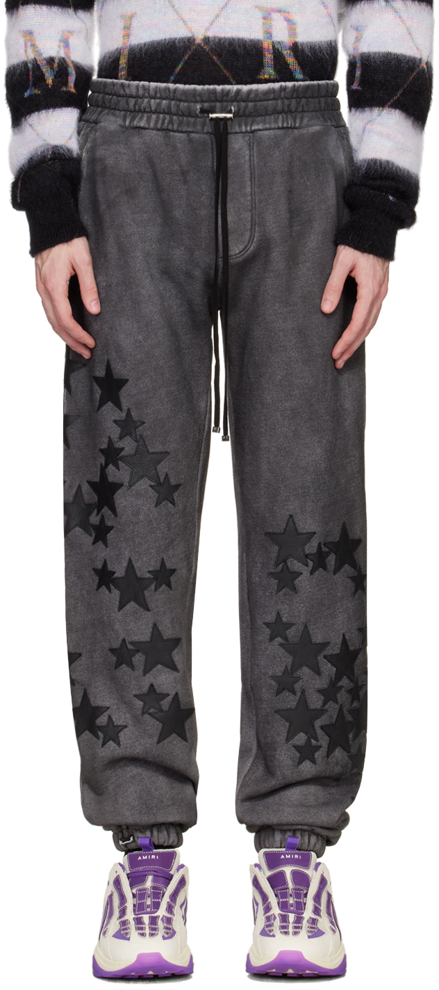 Amiri Pigment Spray Star Tapered Leather-trimmed Cotton-jersey Sweatpants In Heather Black