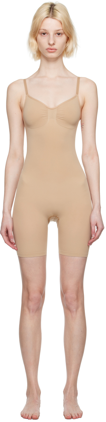 https://img.ssensemedia.com/images/232545F078009_1/skims-beige-seamless-sculpt-mid-thigh-bodysuit.jpg