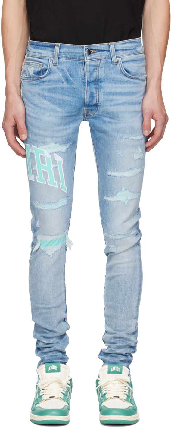 Shop Amiri Blue Embroidered Varsity Logo Repair Jeans In Perfect Indigo