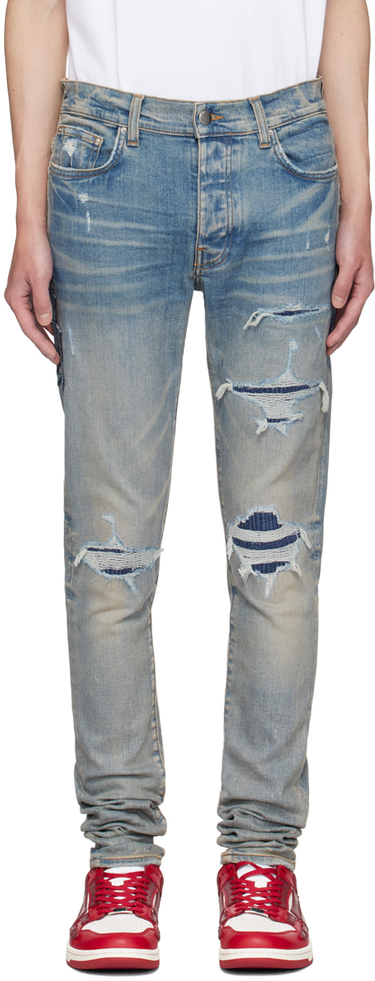 AMIRI: Indigo Varsity Repair Jeans | SSENSE