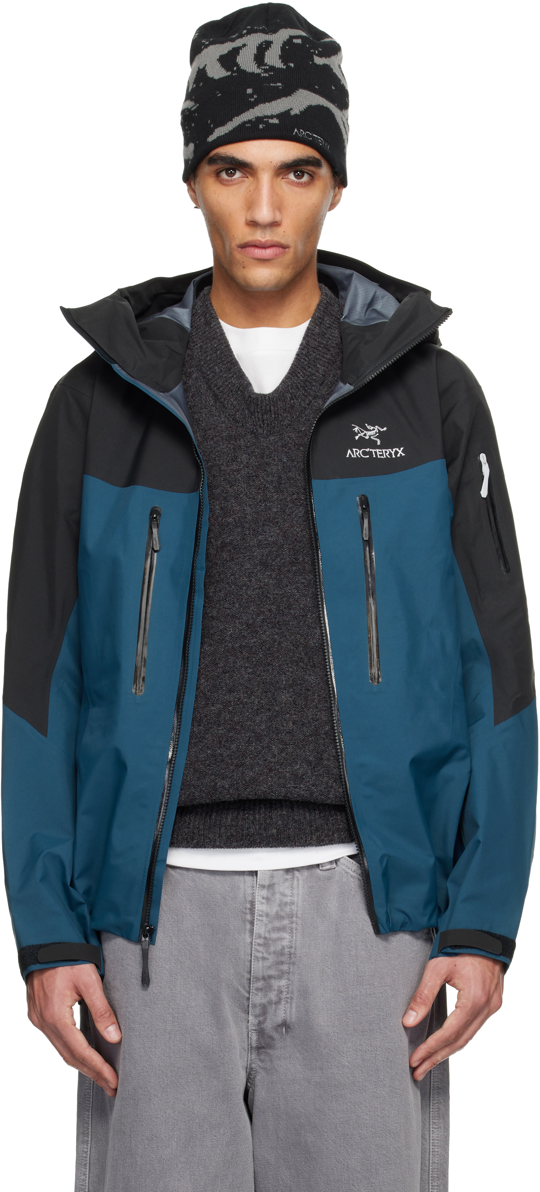 Arc'teryx Alpha SV jacket in Black & Navy, compact alpine shell with pit zips and helmet-compatible hood