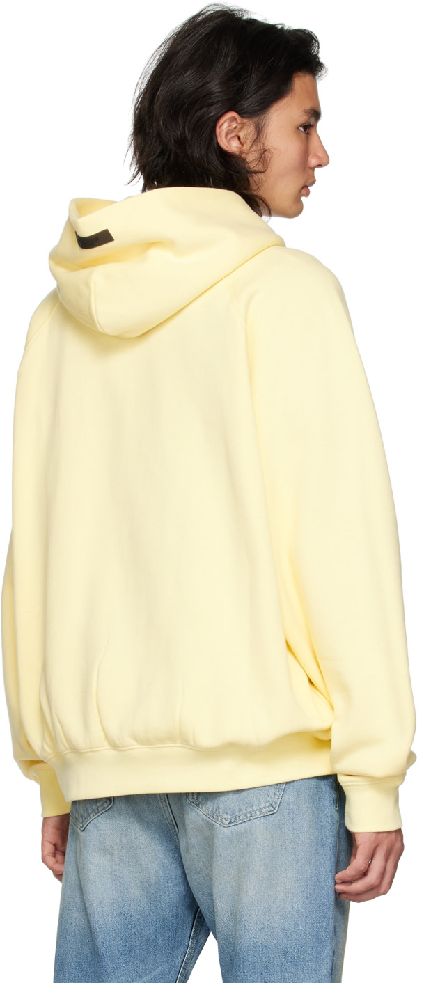 Fear of God ESSENTIALS - Pull à capuche jaune à manches raglan