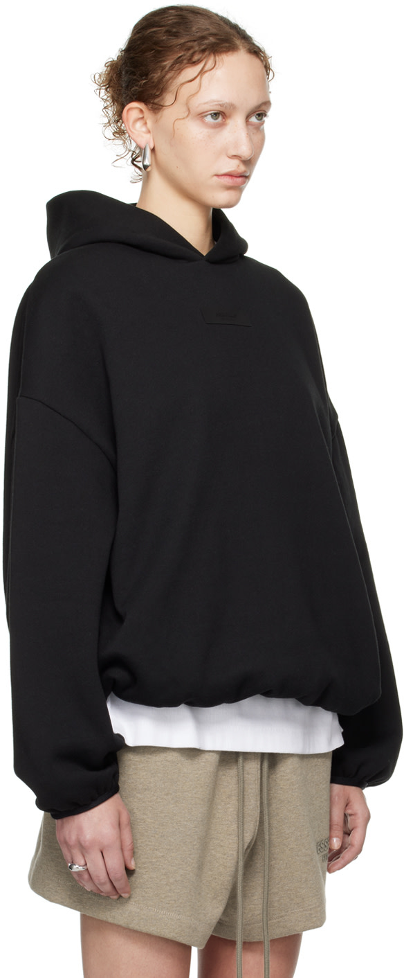 Fear of God ESSENTIALS - Pull à capuche noir à ourlet et poignets élastiques - Core