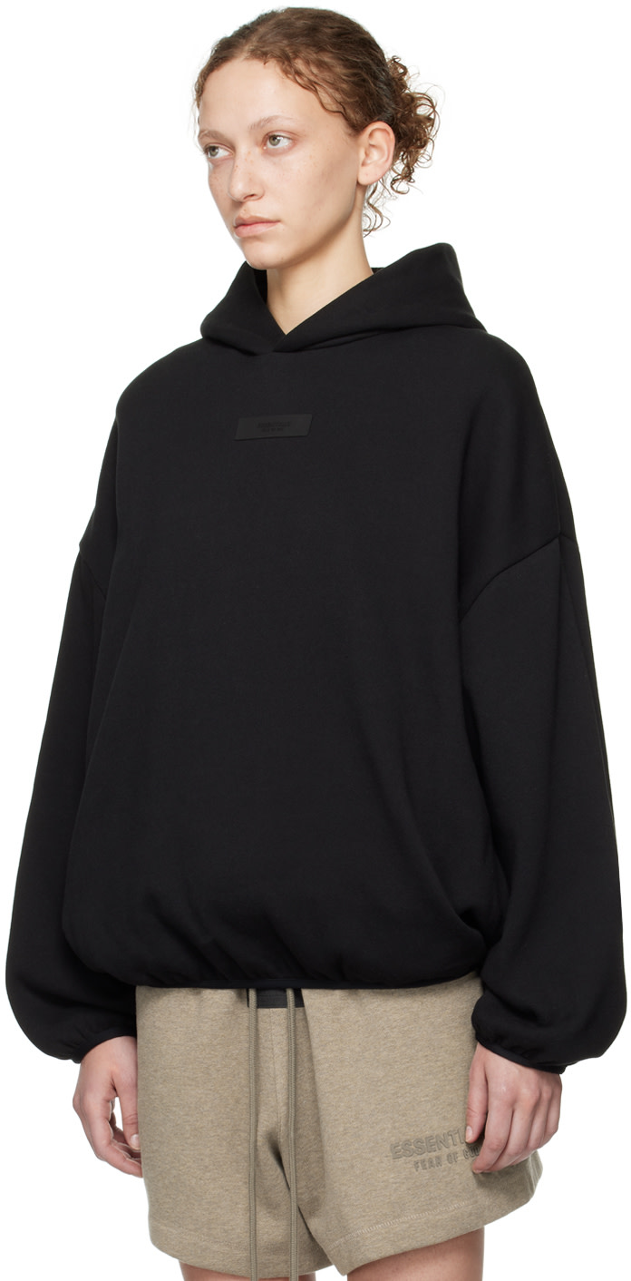 Fear of God ESSENTIALS - Pull à capuche noir à ourlet et poignets élastiques - Core