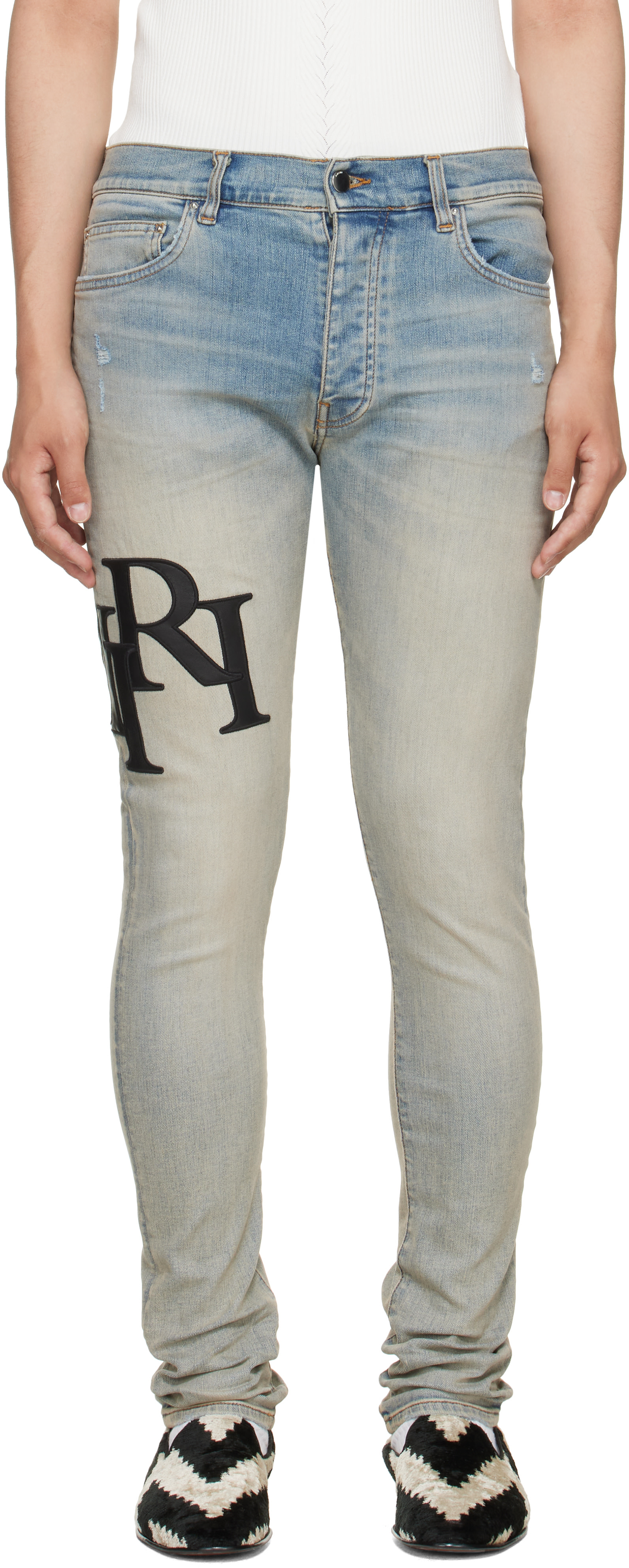 AMIRI: Blue Staggered Logo Skinny Jeans | SSENSE