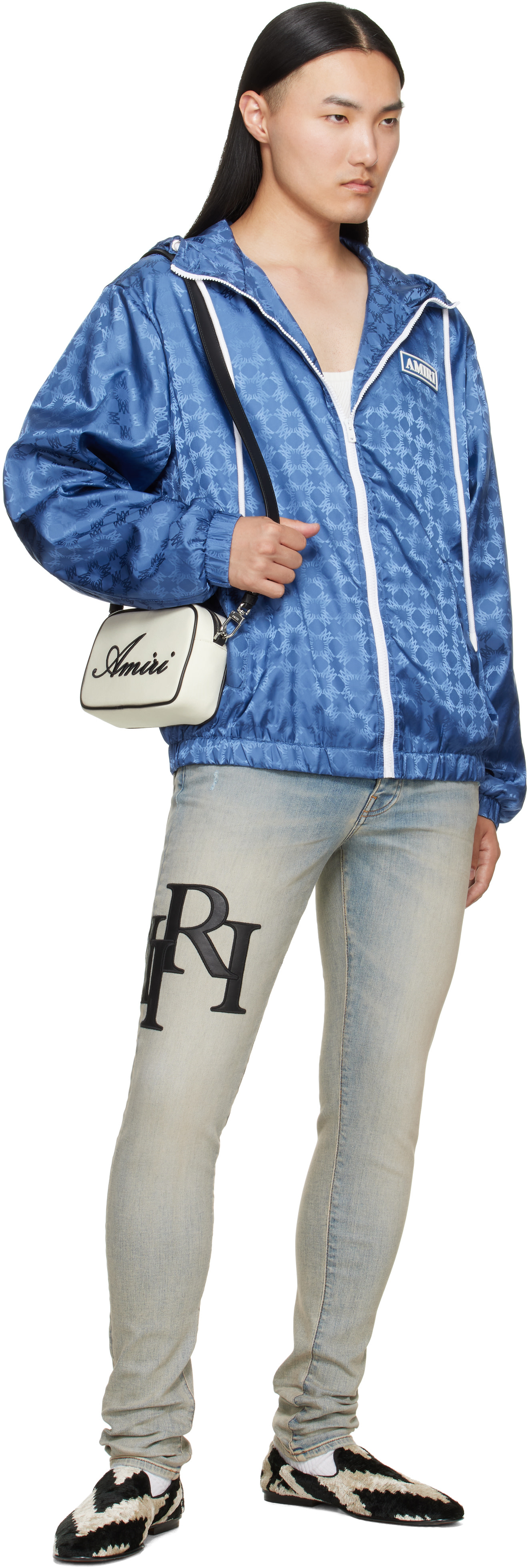 AMIRI: Blue Staggered Logo Skinny Jeans | SSENSE